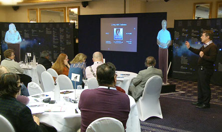 An image of attendees viewing a presentation